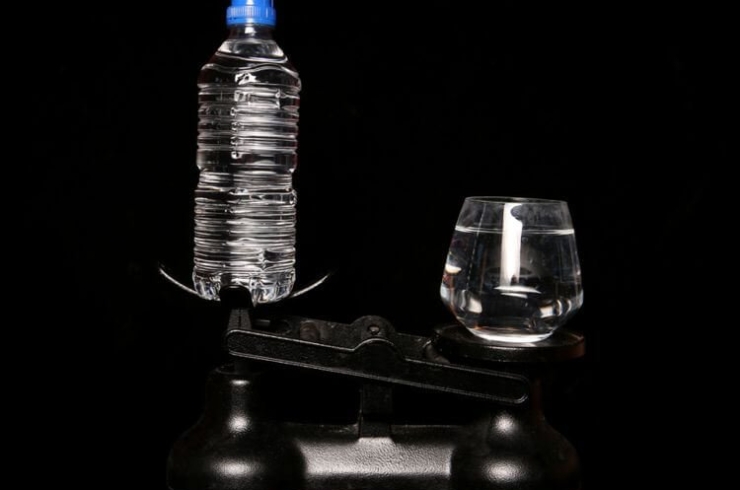 image illustrating bottle and glass on the weighing machine